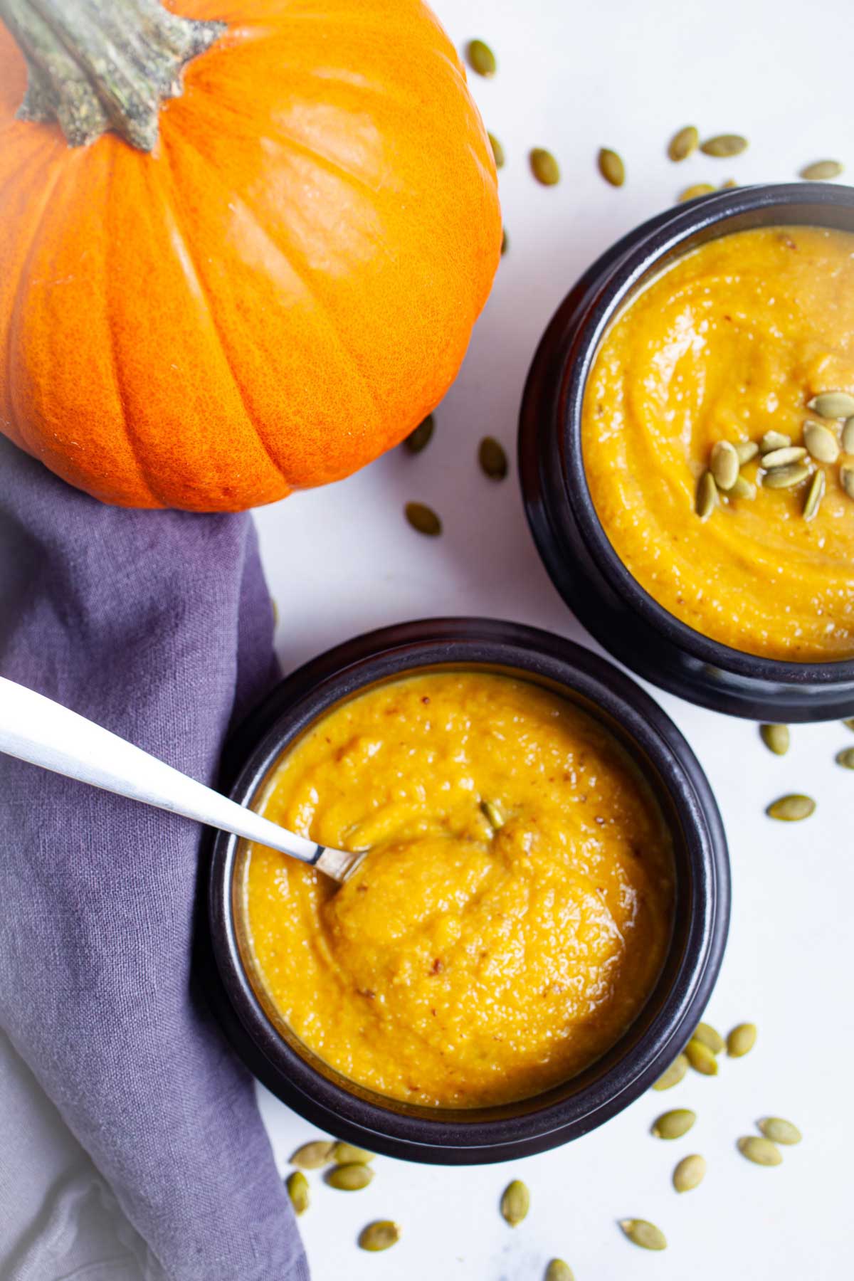 Creamy cauliflower pumpkin soup served in bowls.