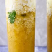 Sparkling pineapple mocktail drink with mint in a tall glass.