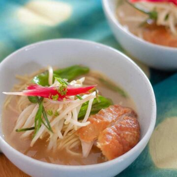 Ramen soup in a bowl topped with veggies.