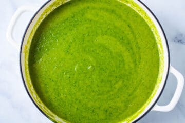 Creamy asparagus soup in a large Dutch pan.