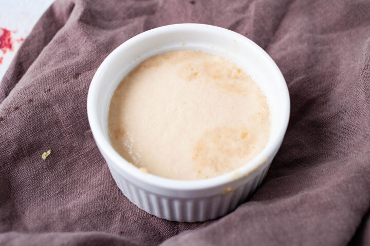 A ramekin filled with half leavened yeast.