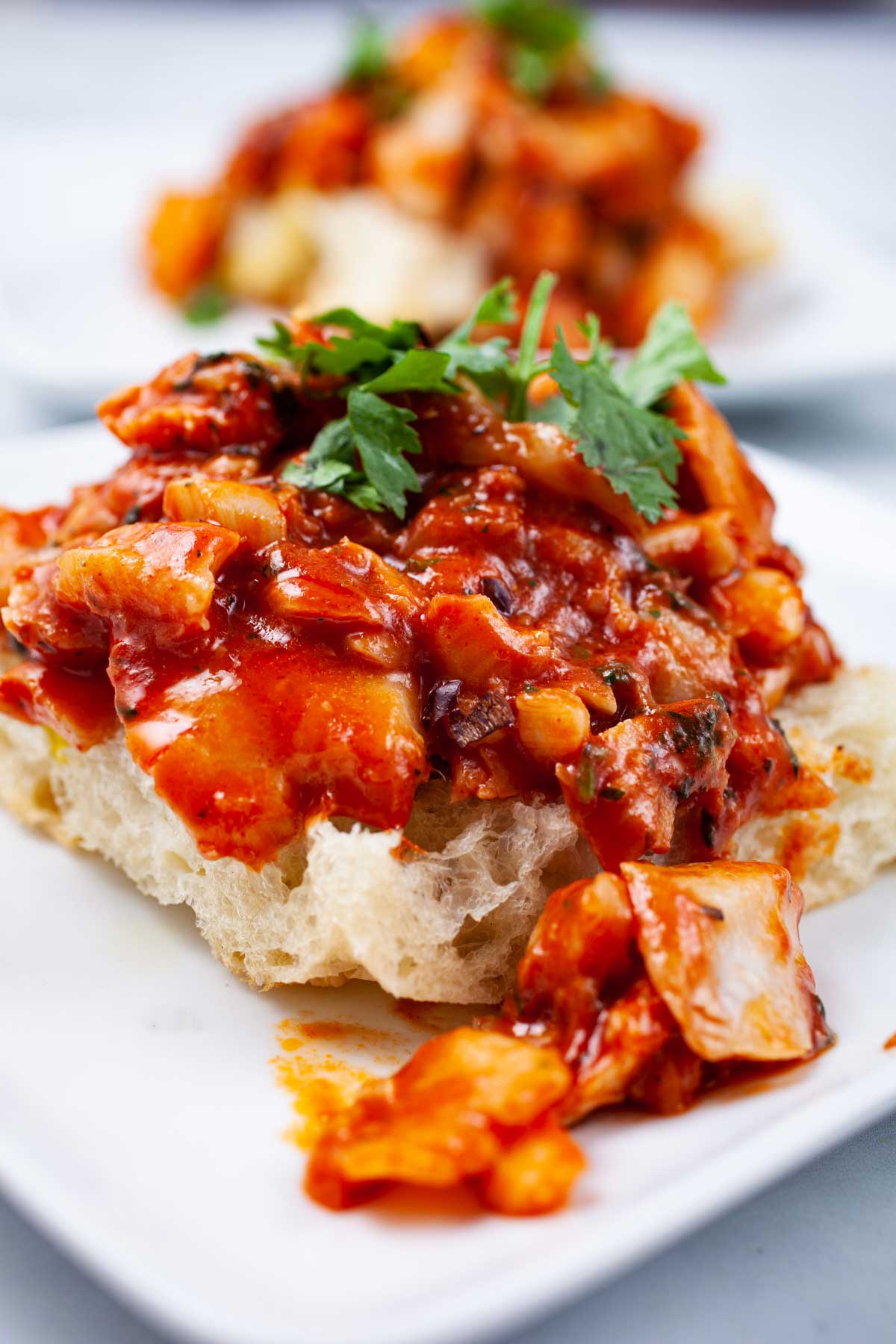 An open Focaccia Sandwich with pan-fried cod fish.