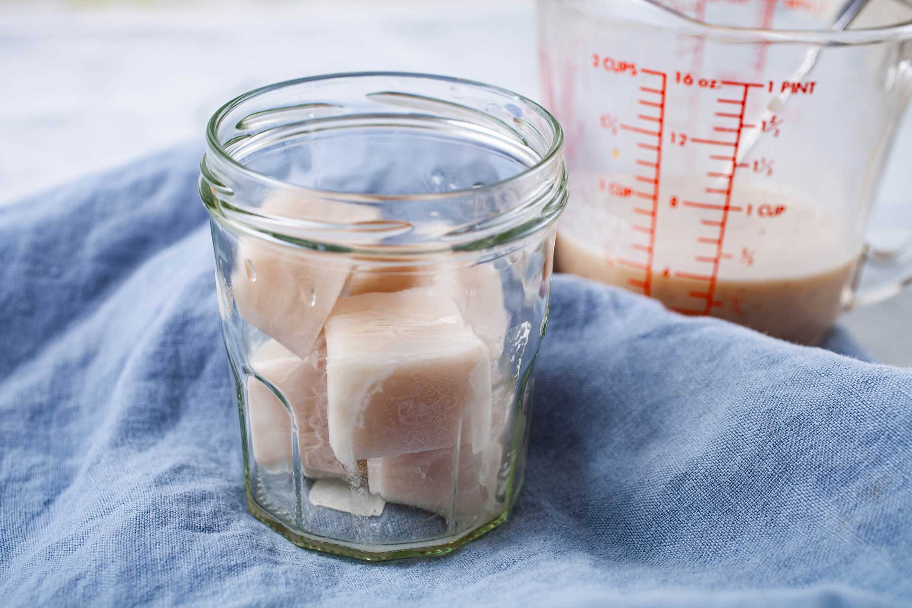 Cashew milk flavored ice cubes in a glass.