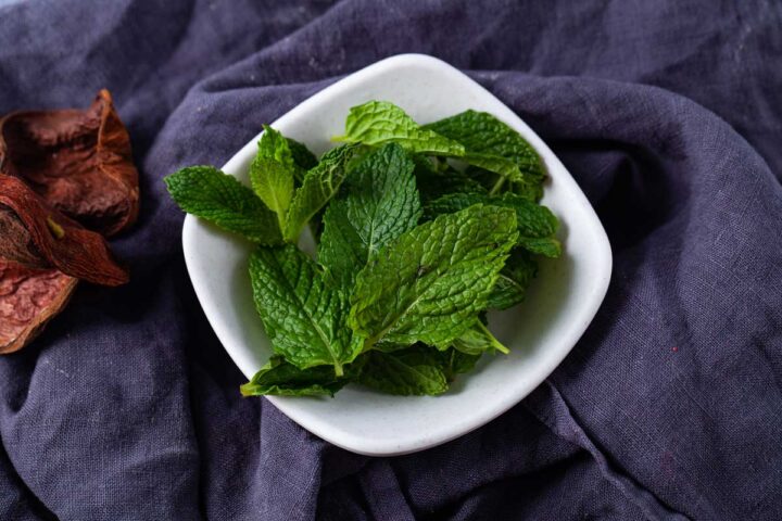 A bowl of fresh mint leaves.