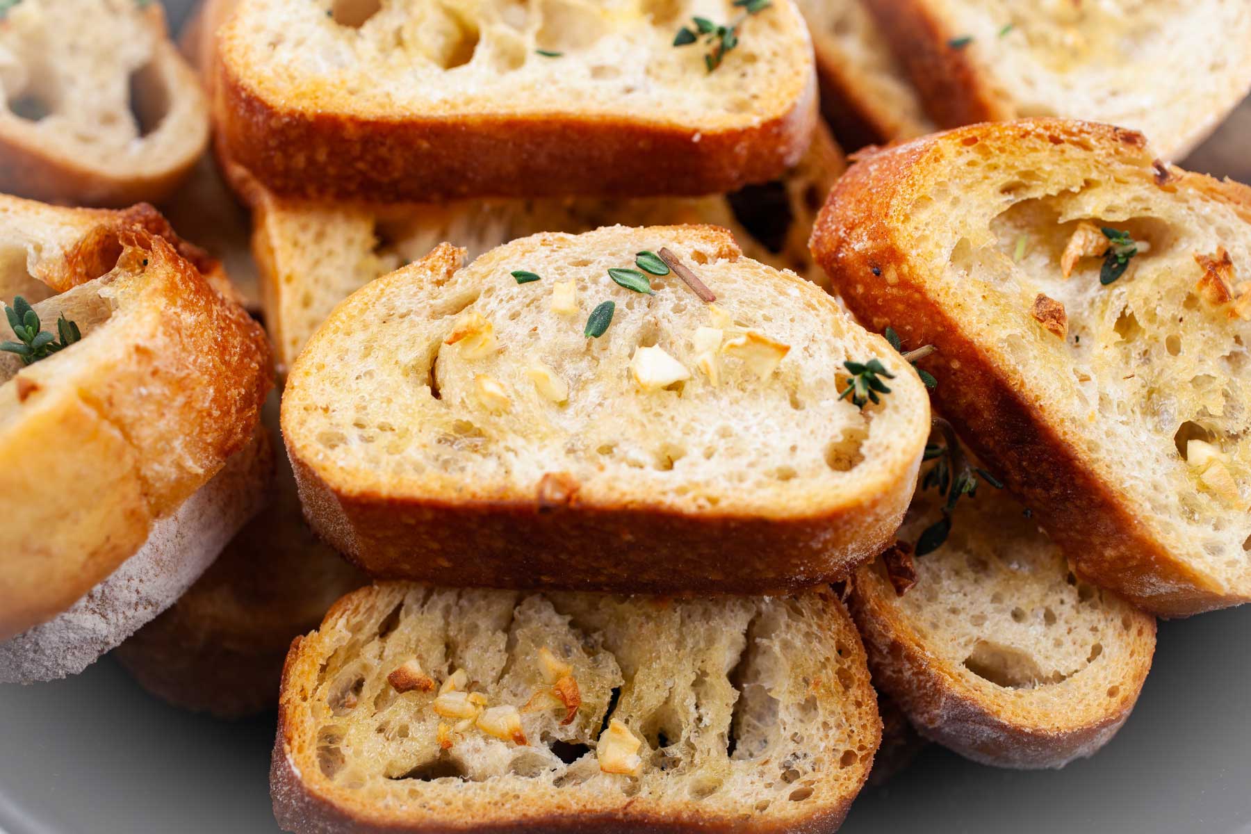 Oven-roasted garlic crostini toasts topped with garlic and fresh herbs.