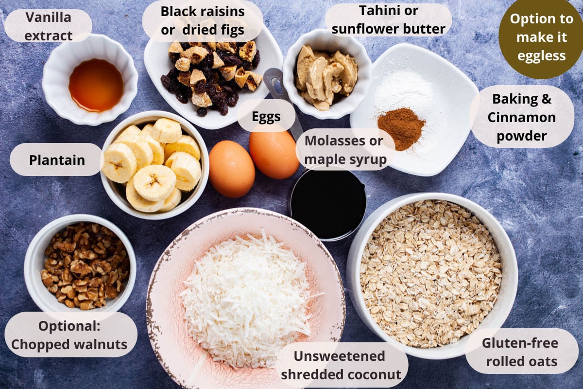 Oats, coconut shreds, chopped walnuts, chopped plantain, two eggs, tahini butter, dried fruits, molasses, and vanilla extract displayed on a table.