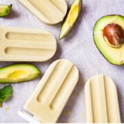 Creamy avocado popsicles on a table.