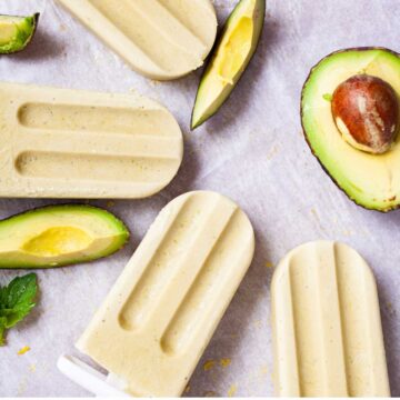 Creamy avocado popsicles on a table.