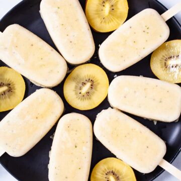 Healthy kiwi popsicles presented on a plate.