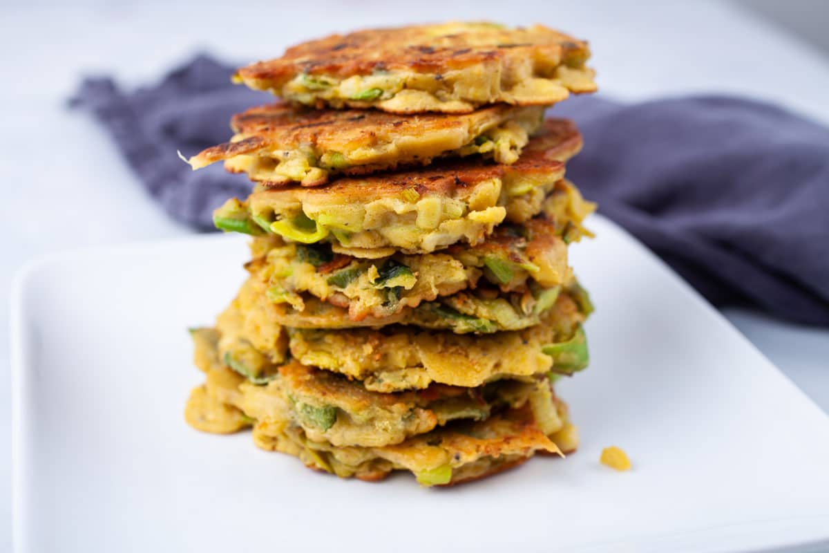 Veggie cakes stacked on top of each other on a plate.