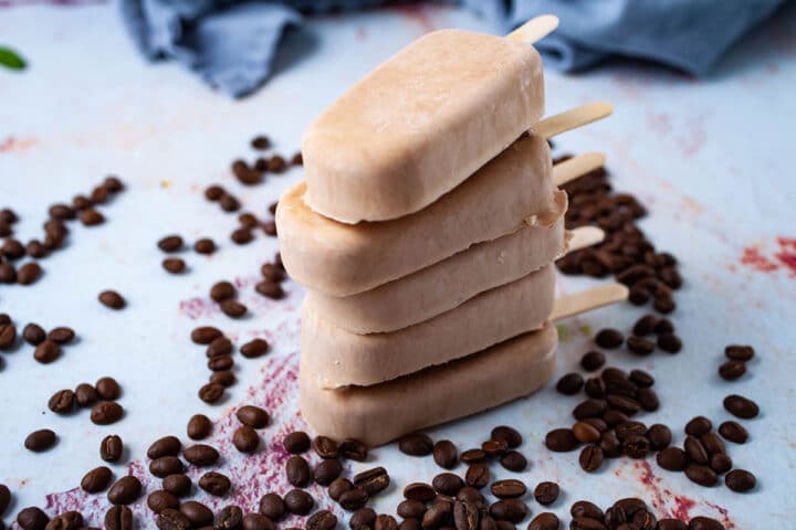 Five coffee flavored creamy Keto ice pops stacked on top of each other.