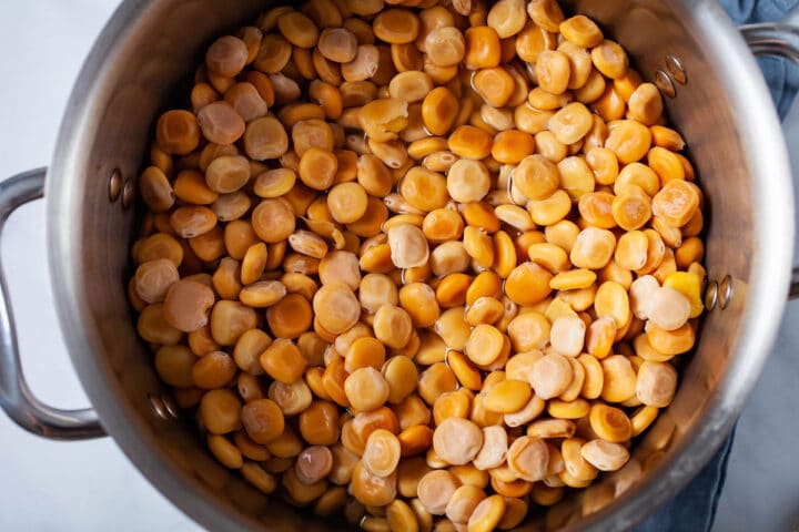 A large pot filled with cooked Lupini beans.