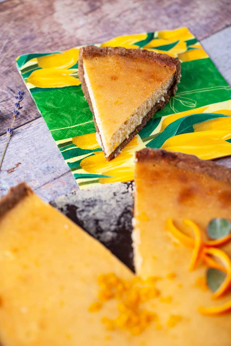 A slice taken out of a whole tart, resting on a napkin.
