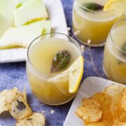 Honeydew lemonade in a glass with basil.