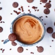 Bone broth hot chocolate in a cup surrounded by chocolate wafers.