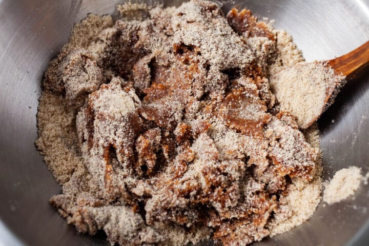Almond flour being mixed in with wet ingredients.