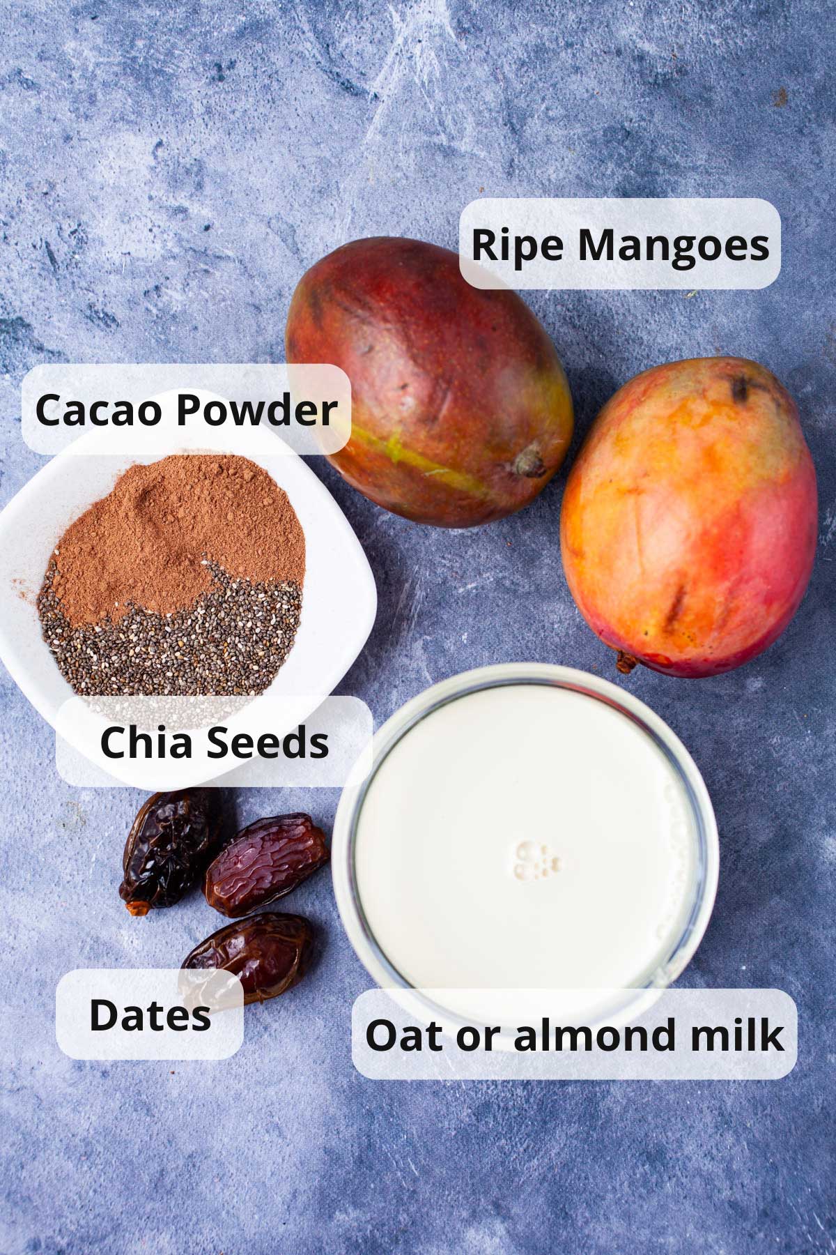 Mangoes, Cacao powder, chia seeds, dates, and plant milk to make a mango smoothie.