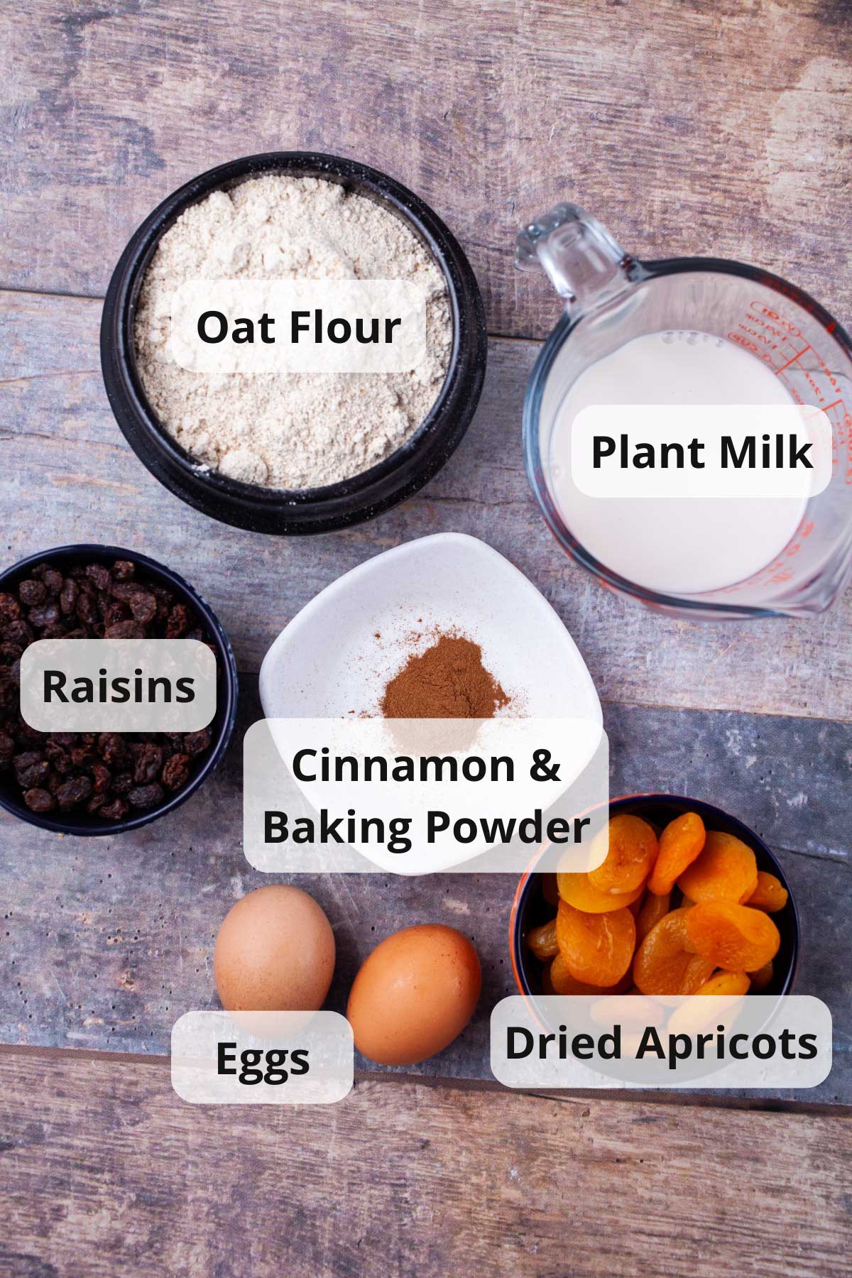 A series of ingredients is displayed on a table to make oat flour pancakes.