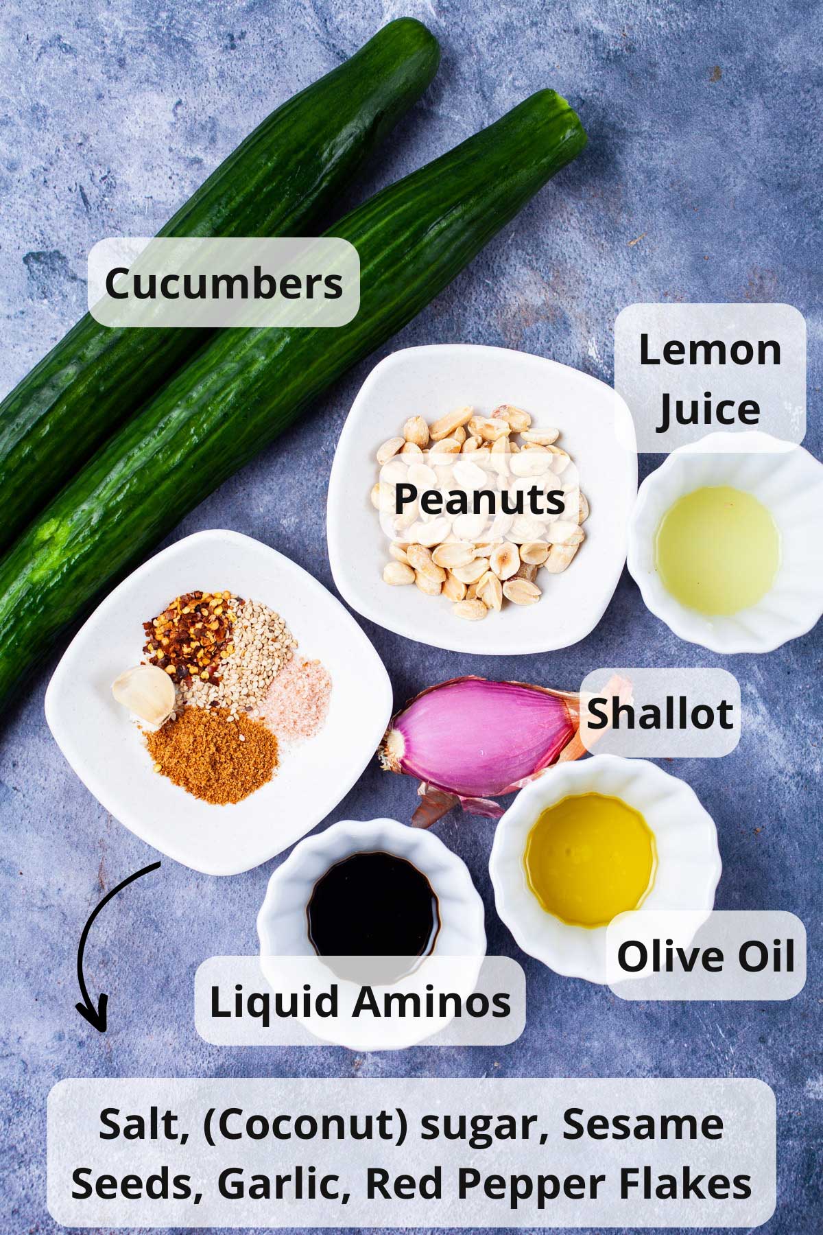 A series of ingredients displayed on a table to make a spicy cucumber salad.