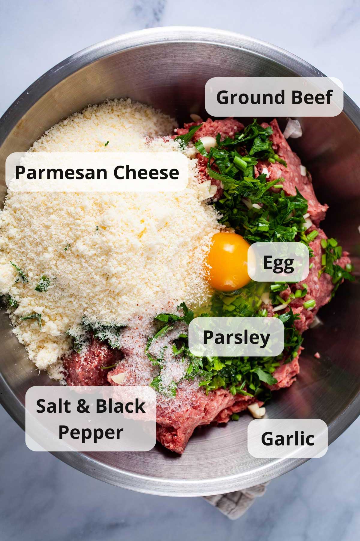 Ingredients combined in a large bowl to make authentic meatballs without breadcrumbs.