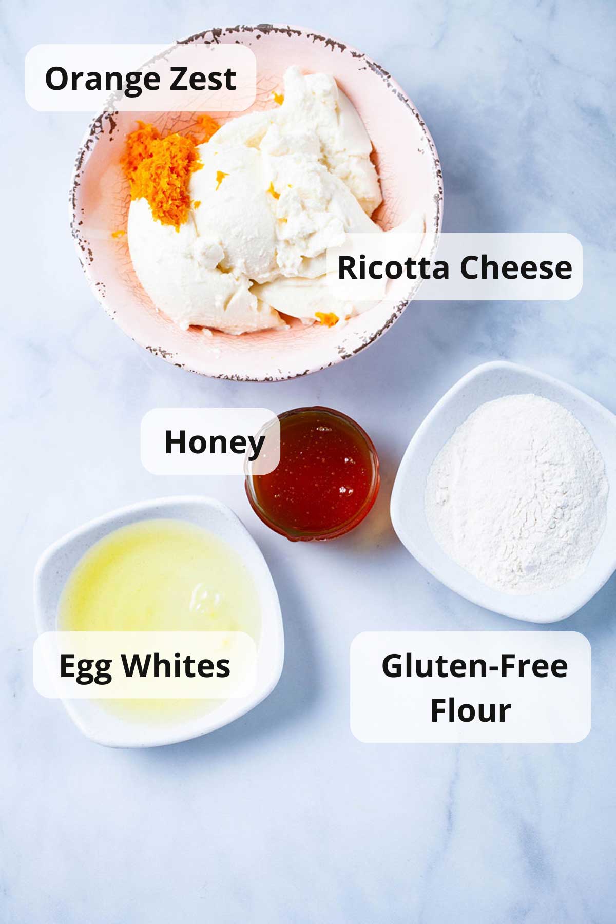 Ingredients displayed on a table to make a ricotta pie filling.