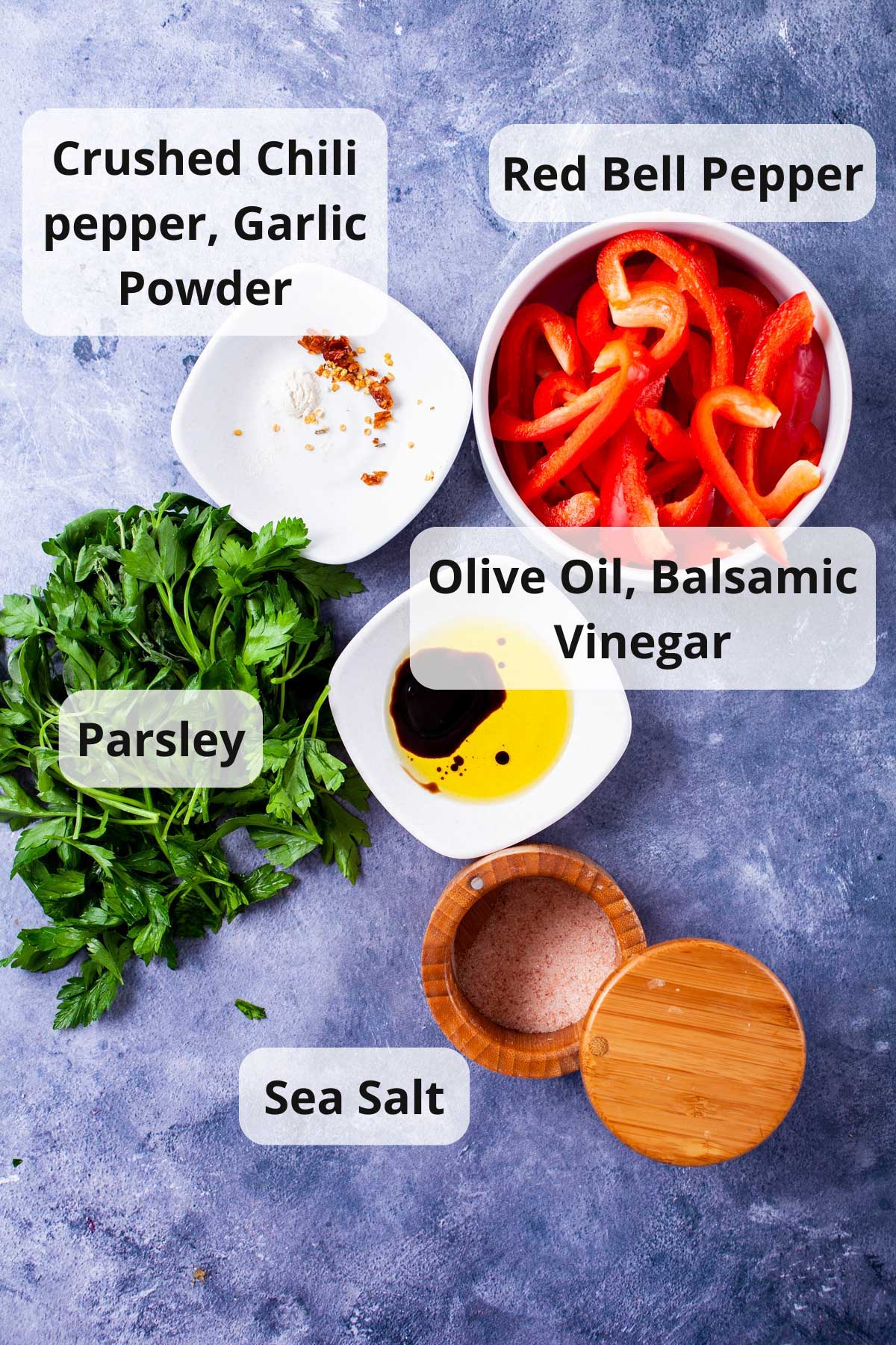 Ingredients displayed on a table to make an Italian red pepper spread.