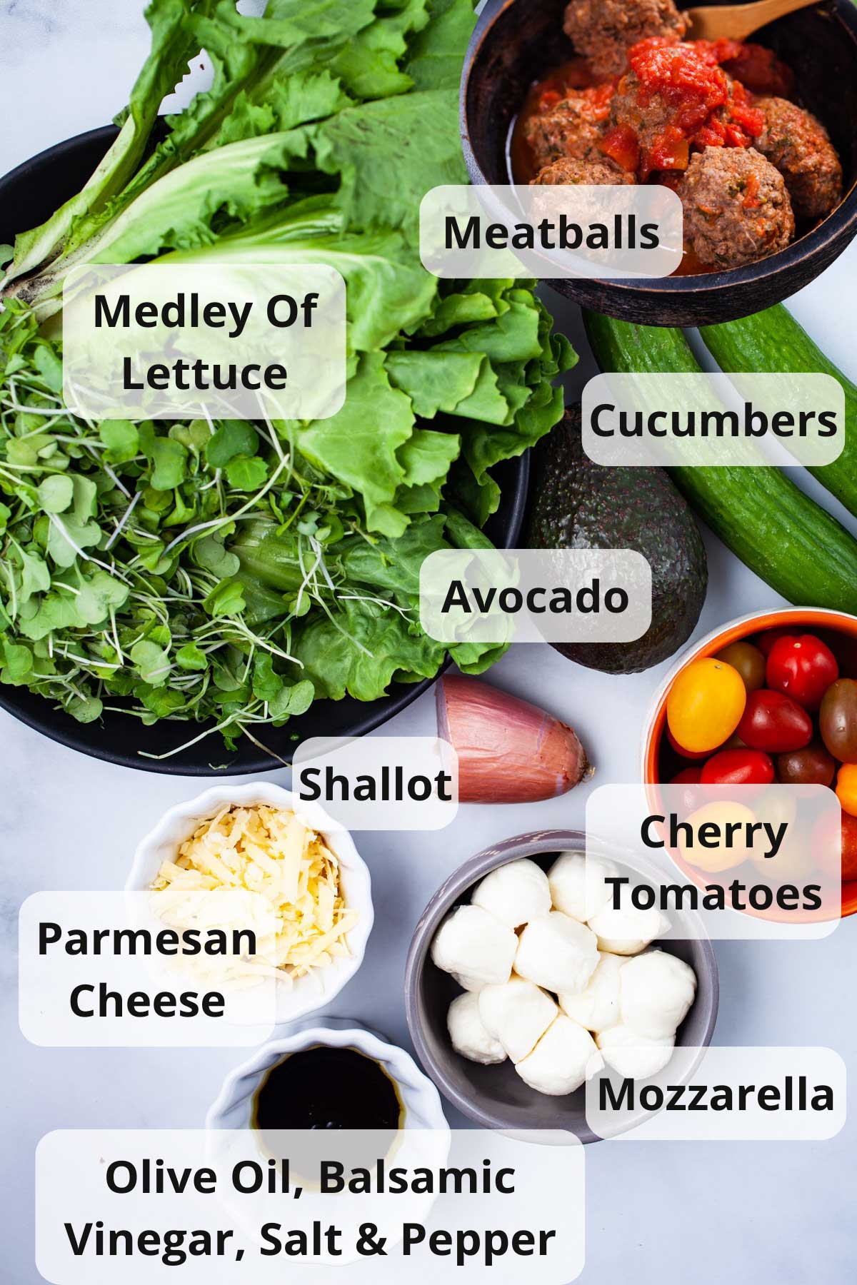 Ingredients displayed on a table to make an Italian meatball salad.