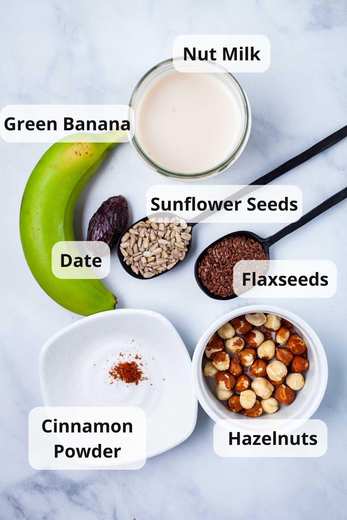 Ingredients to make a seed and nut smoothie displayed on a table.