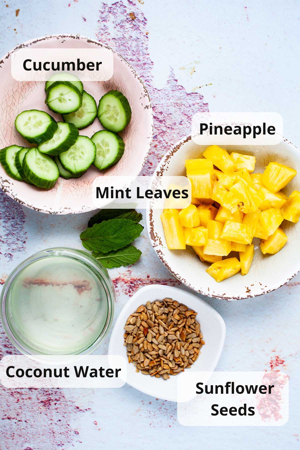 Ingredients on a table to make pineapple cucumber smoothies.