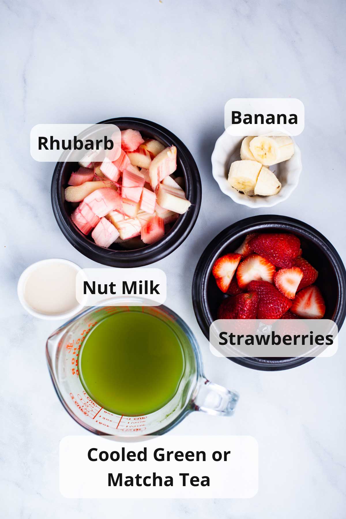 Ingredients to make rhubarb smoothies displayed on a table.