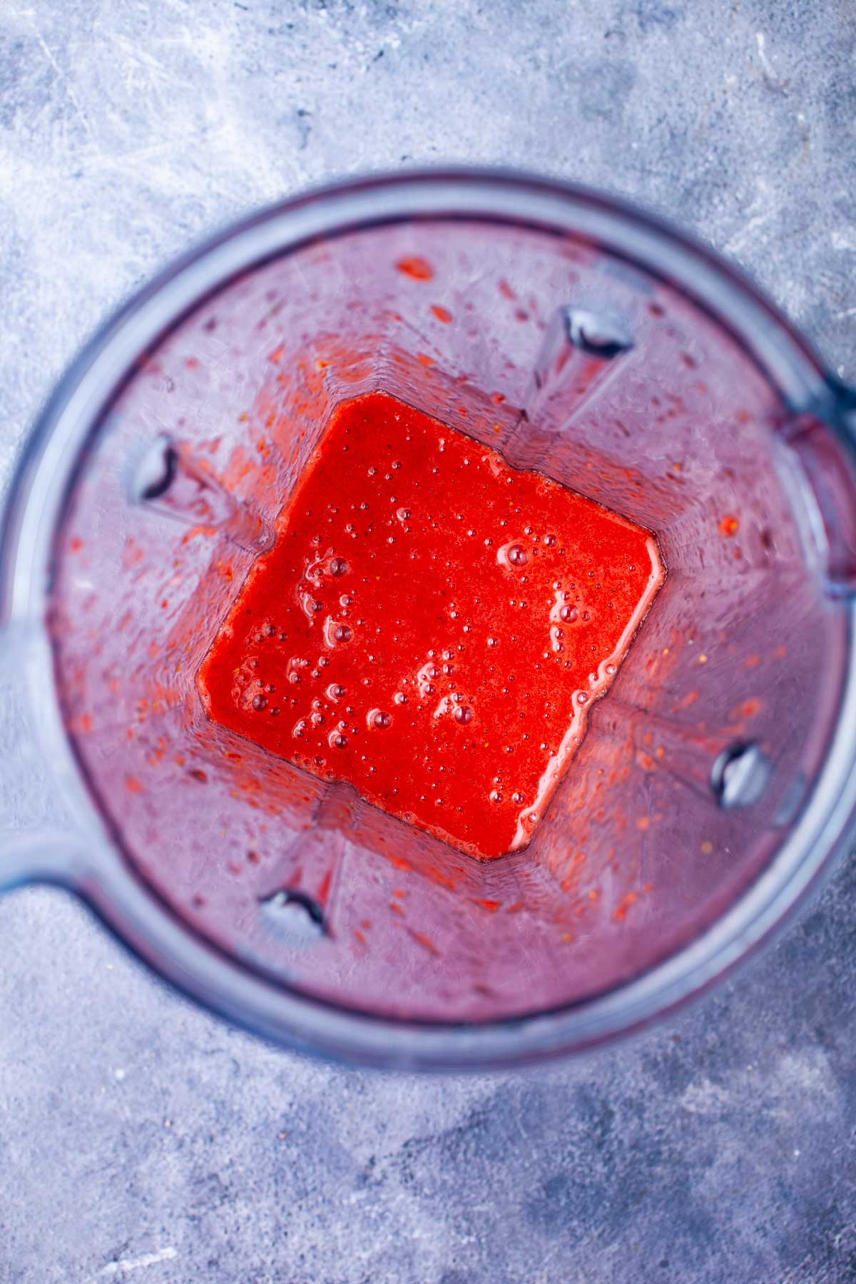 Pureed strawberries in a blender.