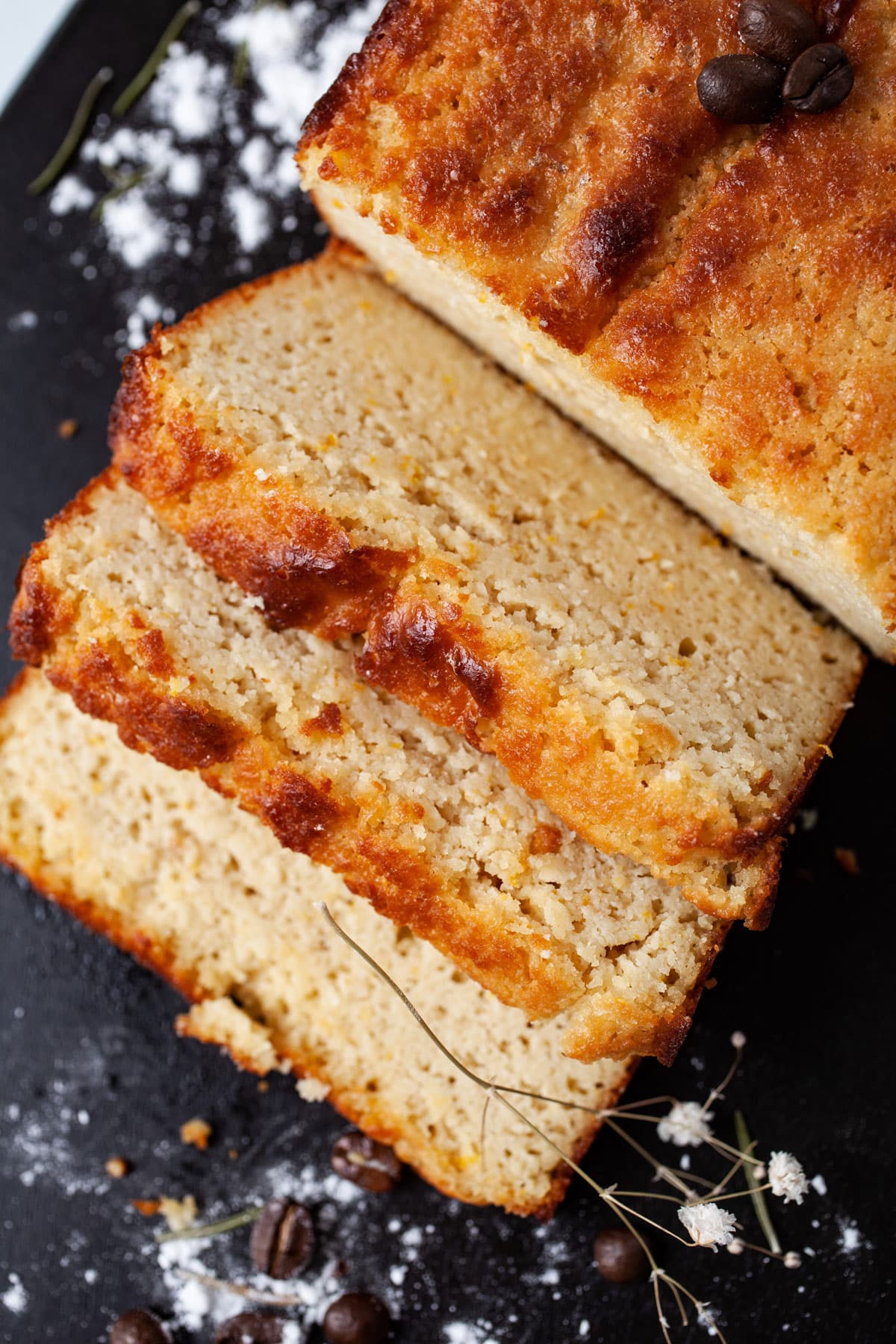 Sliced low carb almond flour yogurt cake on a wooden board.