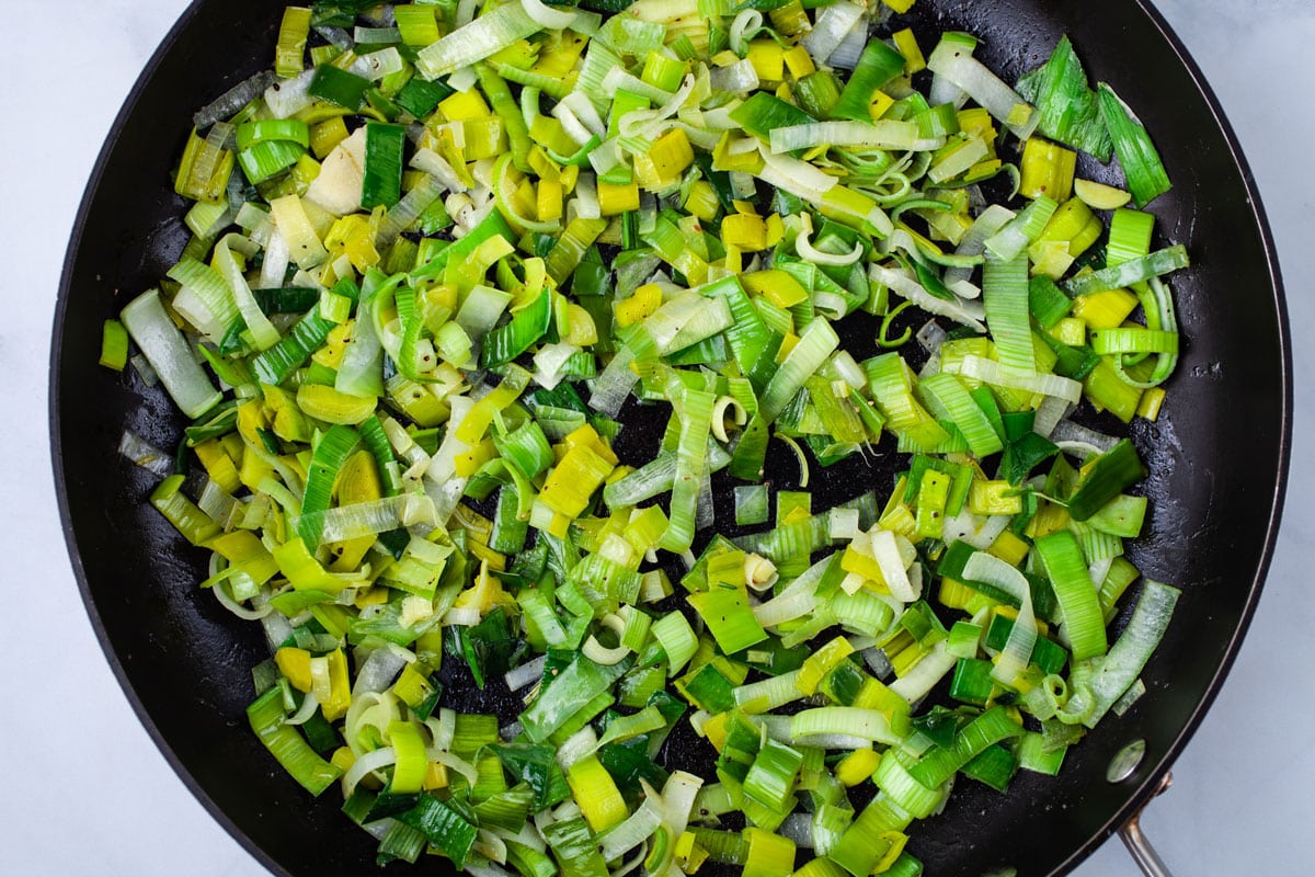 Cooked chopped leek in a large skillet.