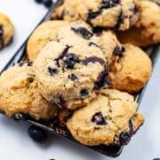Olive oil cookies with lemon and blueberries beautifully displayed on a table.