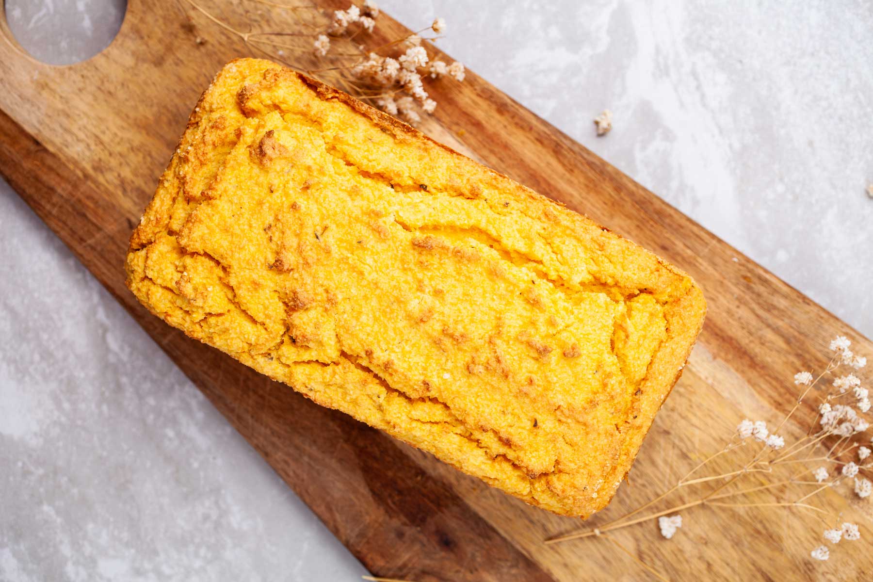 Baked lupin bread on a wooden board.