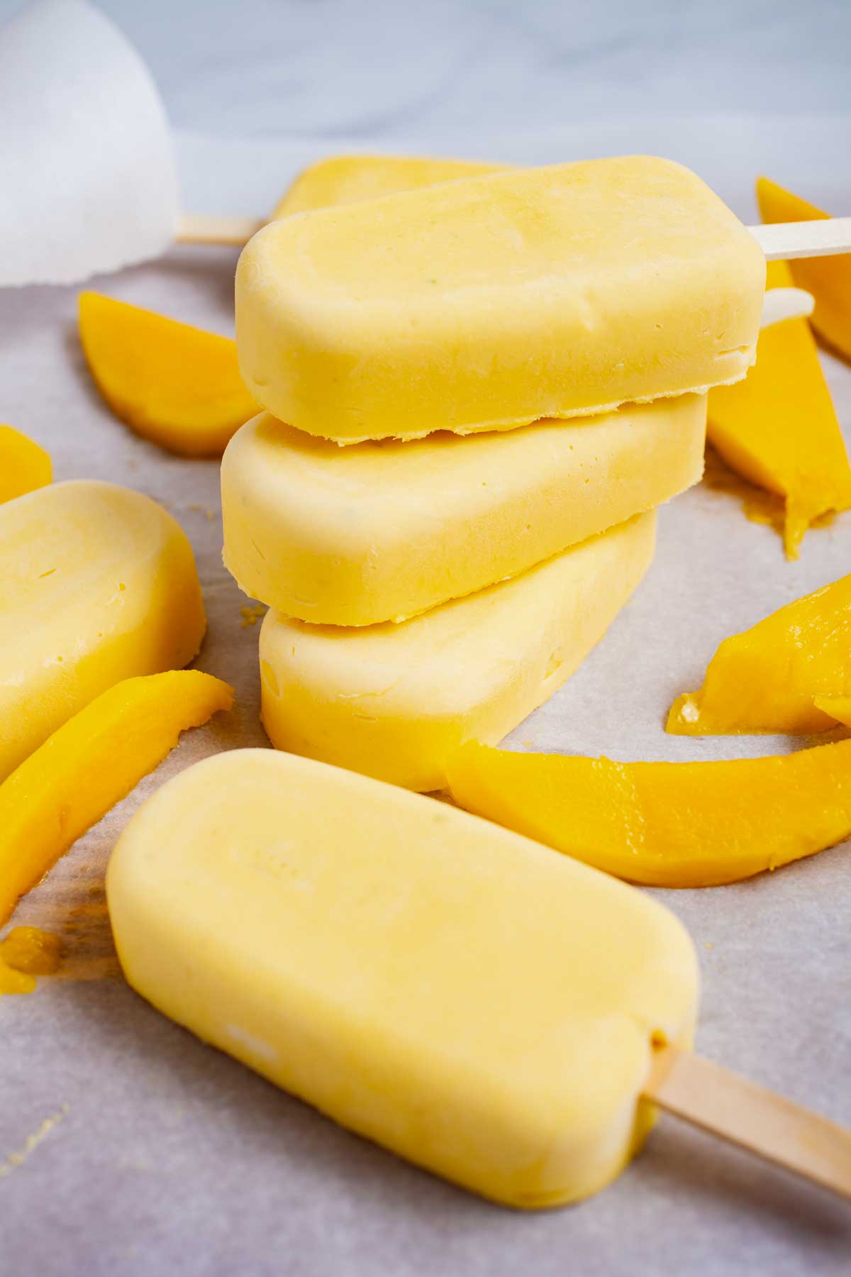Stacked mascarpone mango popsicles.
