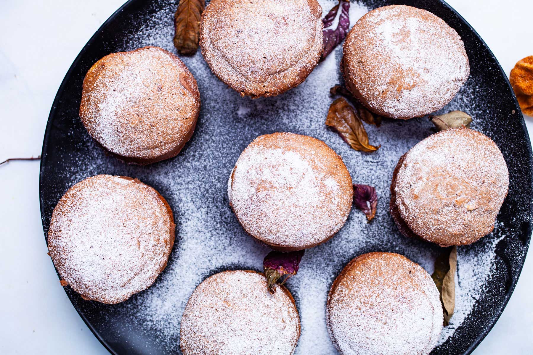 Sugar-dusted mascarpone cookies on a festive plate.