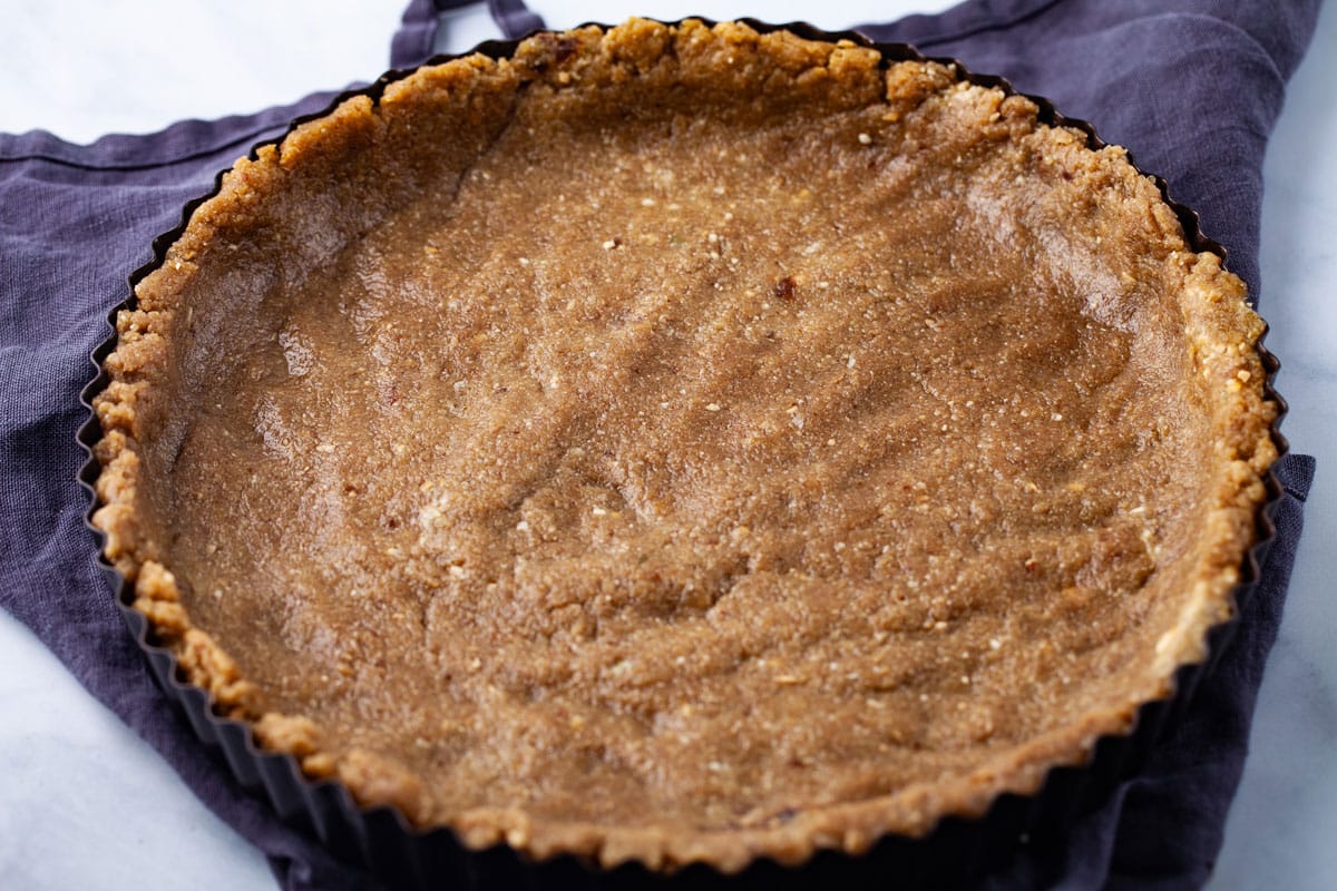 A no-bake tart crust pressed into a round tart form.