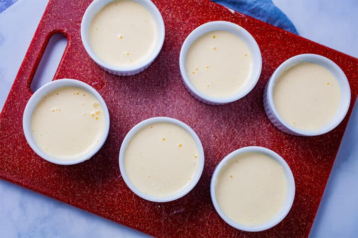 A mascarpone mousse mixture divided into six ramekins.