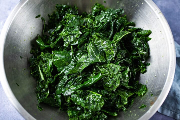 A bowl filled with olive oil massaged green kale.