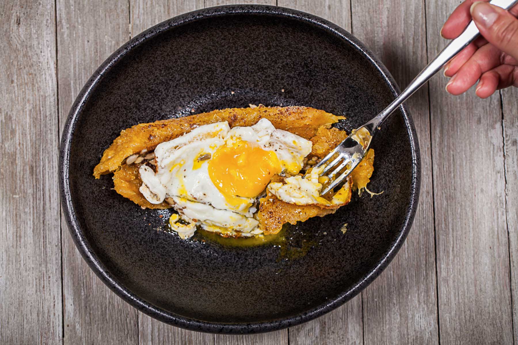 Plantain bowl topped with fried eggs for breakfast.