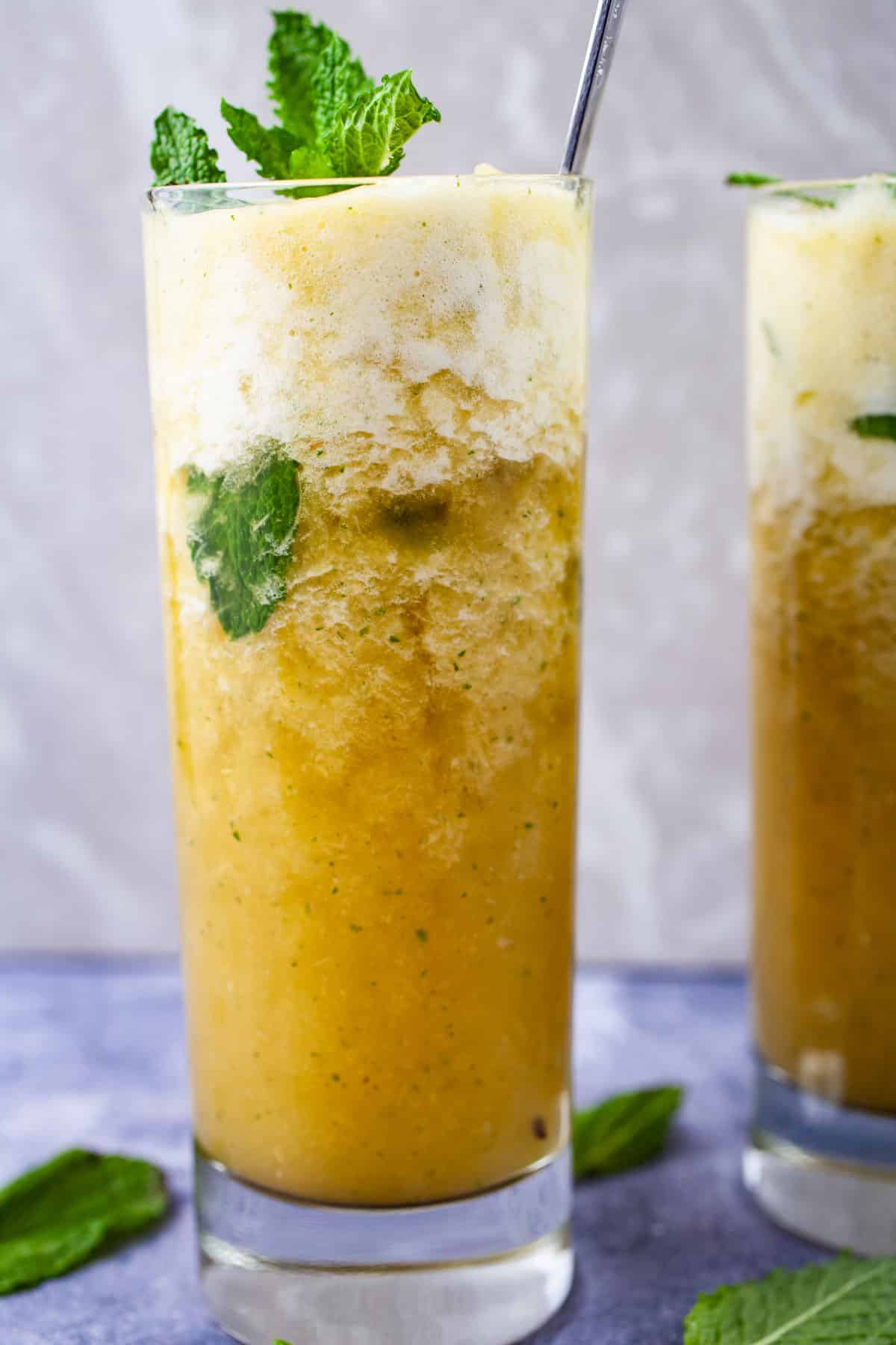 Sparkling pineapple mocktail drink with mint in a tall glass.