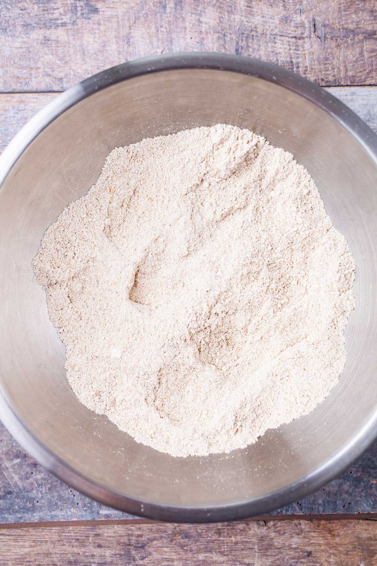 Oat flour in a stainless steel bowl.
