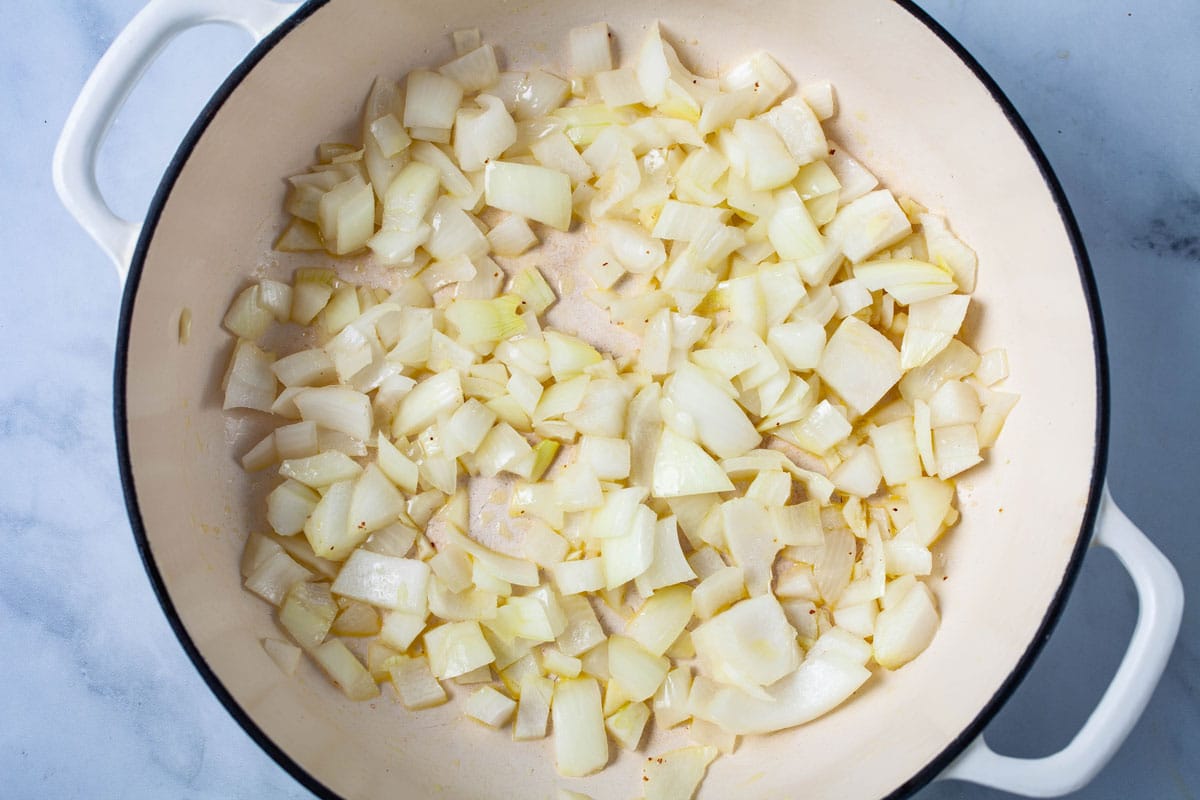 Chopped onions in a large Dutch Pan.