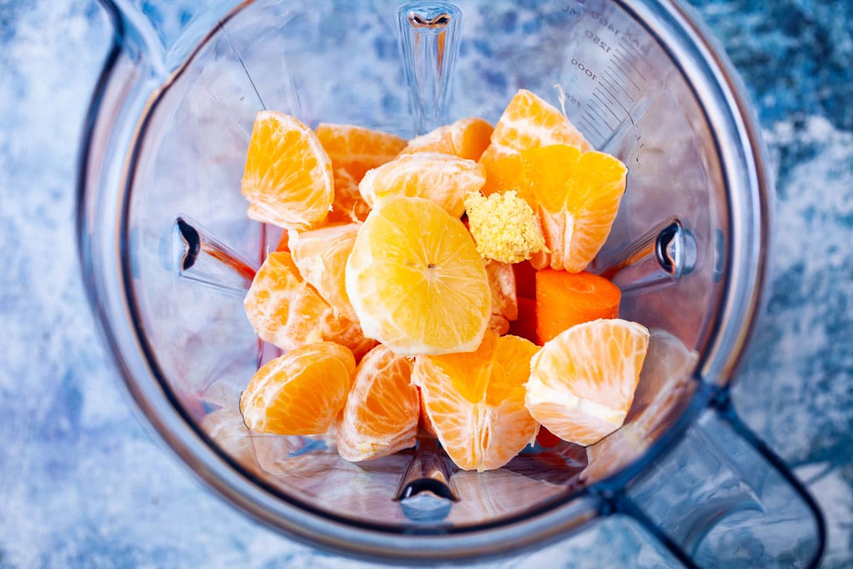 Chopped carrots, oranges and grated ginger in a blender.