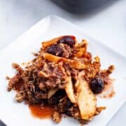 Healthy Paleo apple crumble with cherries served on a plate.