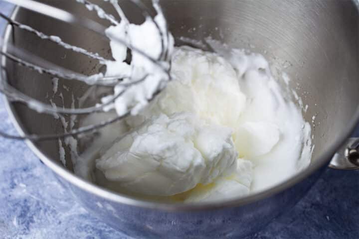 Whipped egg whites in a mixing bowl.