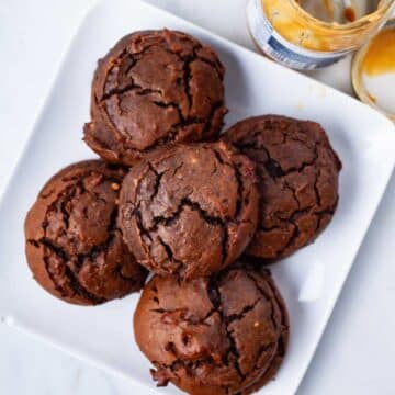 Brownie Peanut Butter Cookies stacked on a plate.