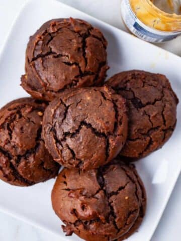 Brownie Peanut Butter Cookies stacked on a plate.