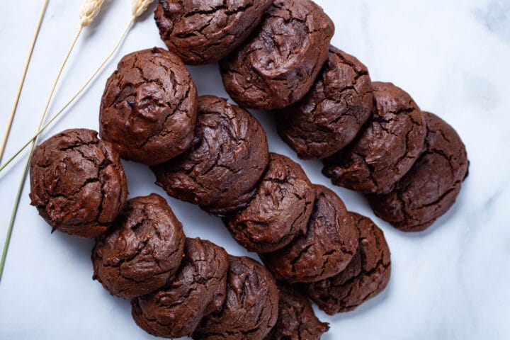 Beautiful crackly brown baked flourless peanut butter cookies nicely arranged on a table.